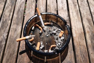 High angle view of cigarette on wood