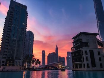 Skyscrapers lit up at sunset