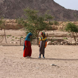 Rear view of people walking on mountain