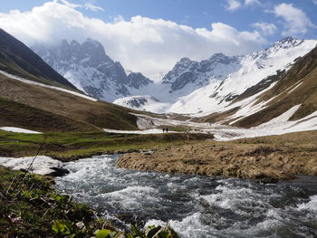 Scenic view of snowcapped mountains against sky