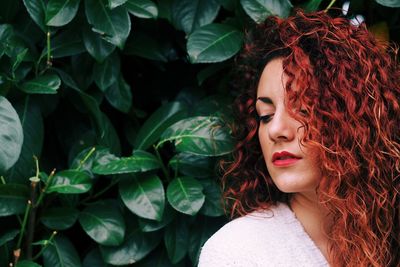 Close-up of young woman with plants