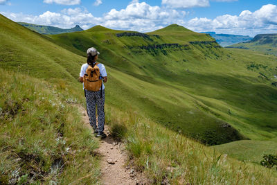 Rear view woman walking on trail