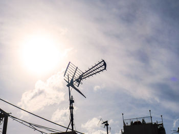 Low angle view of crane against sky