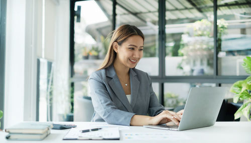 Businesswoman using laptop at office