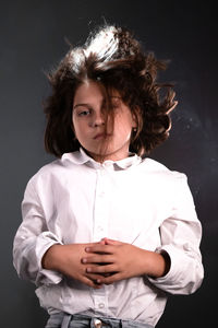 Portrait of woman against black background