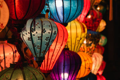 Low angle view of illuminated lanterns hanging at night