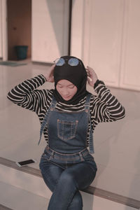 High angle view of teenage girl sitting on floor