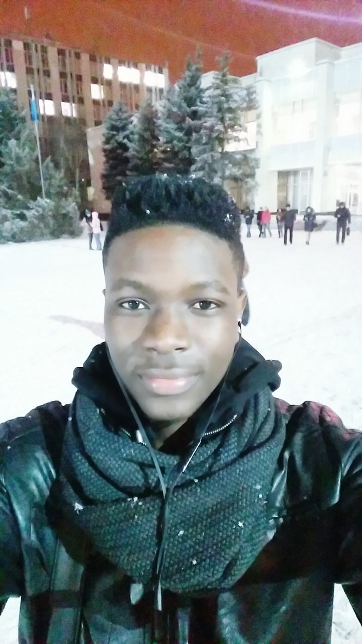 lifestyles, portrait, looking at camera, leisure activity, building exterior, young adult, person, front view, built structure, winter, architecture, warm clothing, casual clothing, smiling, cold temperature, young men, incidental people, snow