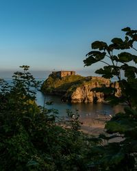 Scenic view of bay against clear sky