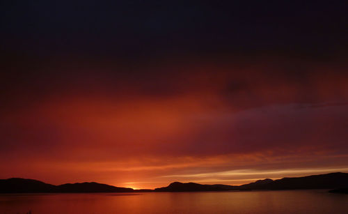 Scenic view of sea against romantic sky at sunset