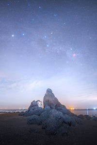 Scenic view of mountains against sky at night