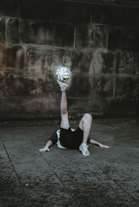 Adult playing football on the street