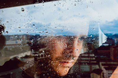 Close-up portrait of wet glass window in rainy season