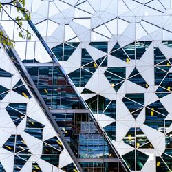 Low angle view of modern glass building in city