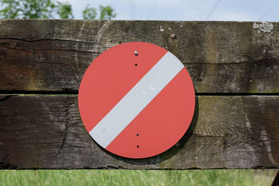 Close-up of road sign on wooden post