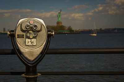 Close-up of binoculars against sky
