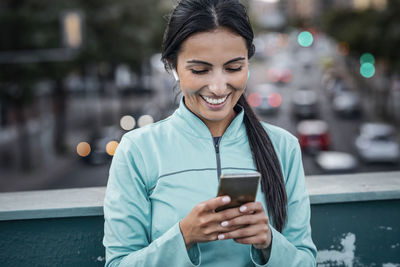 Happy woman surfing net through mobile phone