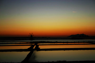 Scenic view of sea against clear sky during sunset