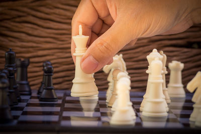 Close-up of hand playing chess 