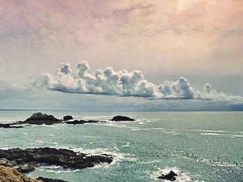 Scenic view of sea against cloudy sky