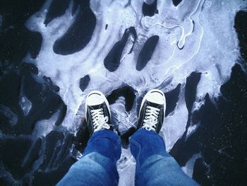 Low section of person standing on tiled floor