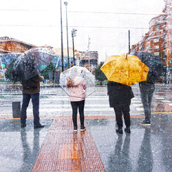 People with an umbrella in rainy days in bilbao city, spain