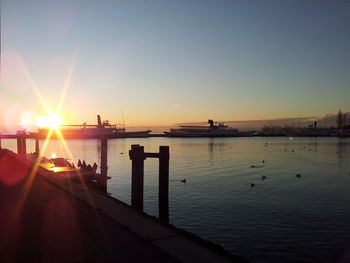 Pier on sea at sunset