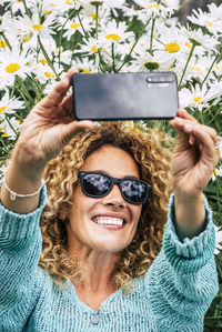 Portrait of young woman using mobile phone