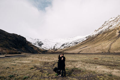 Man standing on mountain against sky