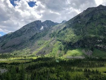 Scenic view of green mountains against sky