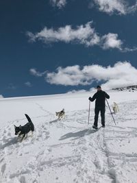 Man on snow covered mountain against sky