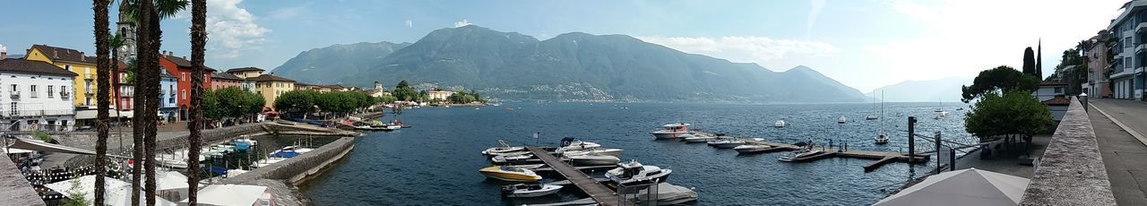 PANORAMIC VIEW OF BOATS MOORED IN WATER AGAINST SKY