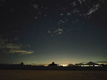 Scenic view of silhouette landscape against sky at night