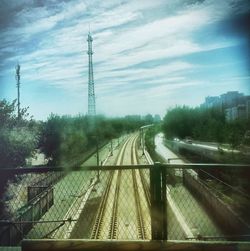 Railroad track against cloudy sky