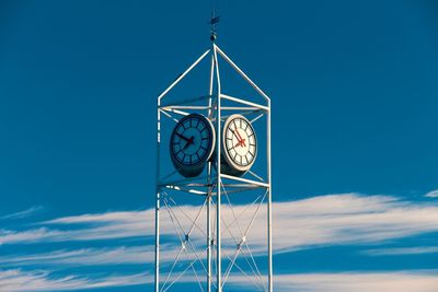 Low angle view of clock tower against blue sky