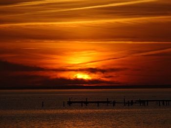 Scenic view of sea against orange sky