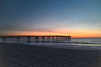 Scenic view of beach against sky during sunset