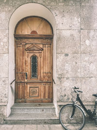 Old wooden door with a bicycle parked next to it on the street