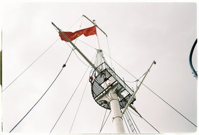 Low angle view of crane against sky