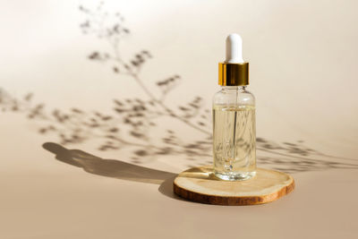 Natural oil cosmetics on neutral. dropper glass bottle mock-up. oily cosmetic pipette. face body spa