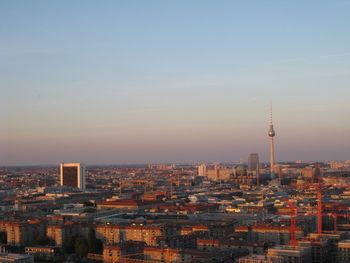 Cityscape against sky at sunset