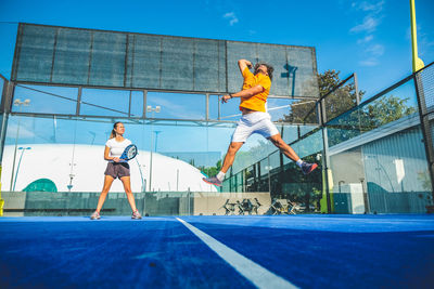 Low angle view of tennis players playing at court