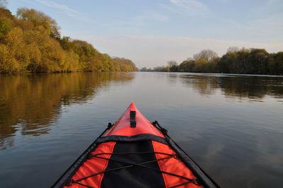 Cropped image of kayak in lake against sky