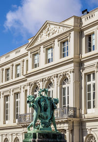 Low angle view of statue against building in city