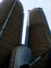 Low angle view of factory against sky