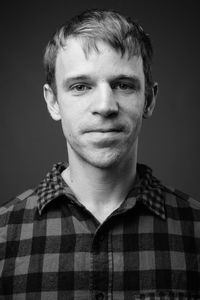 Portrait of young man against gray background