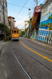 Yellow vintage tramway going up hill in santa teresa neighborhood in rio de janeiro