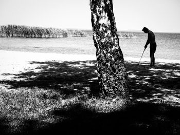 Silhouette of woman standing on lakeshore
