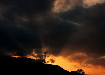 Silhouette landscape against dramatic sky