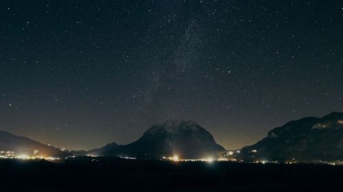 Scenic view of mountains against sky at night